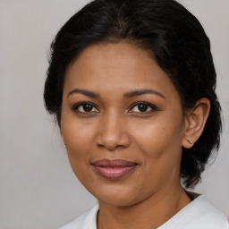 Joyful black young-adult female with medium  brown hair and brown eyes