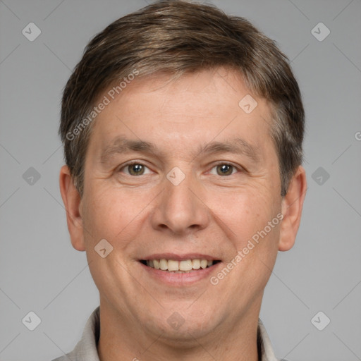 Joyful white adult male with short  brown hair and brown eyes