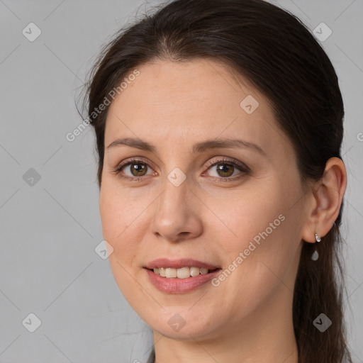 Joyful white adult female with long  brown hair and brown eyes