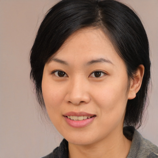Joyful asian young-adult female with medium  brown hair and brown eyes