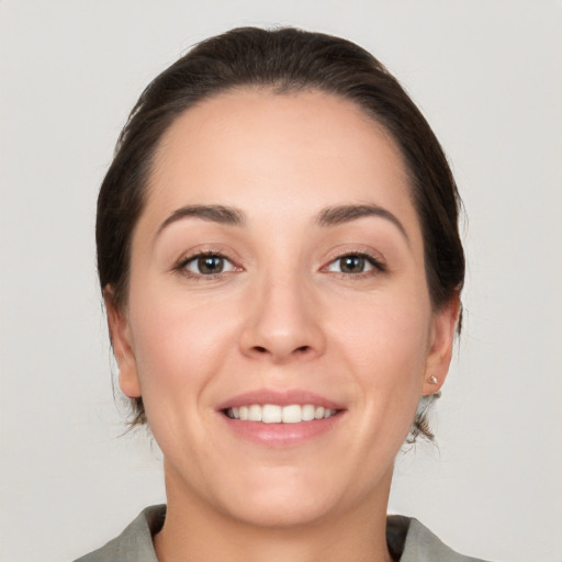 Joyful white young-adult female with medium  brown hair and brown eyes