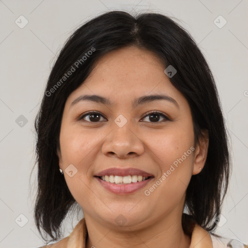 Joyful latino young-adult female with medium  brown hair and brown eyes