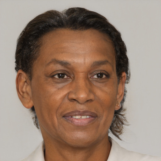 Joyful black adult female with short  brown hair and brown eyes