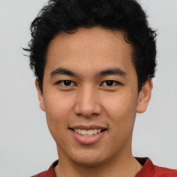 Joyful latino young-adult male with short  brown hair and brown eyes