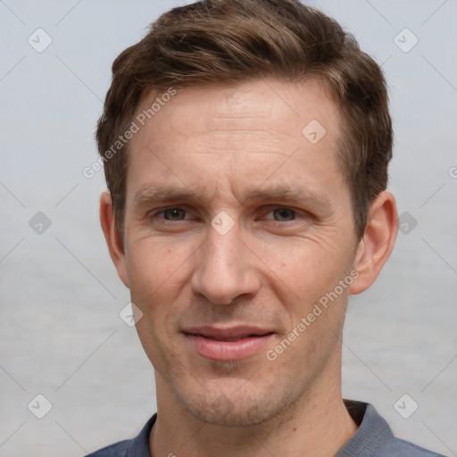 Joyful white adult male with short  brown hair and grey eyes