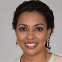 Joyful black young-adult female with medium  brown hair and brown eyes