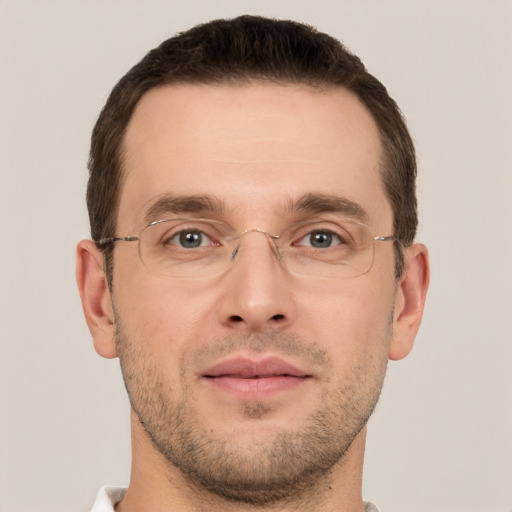 Joyful white young-adult male with short  brown hair and grey eyes