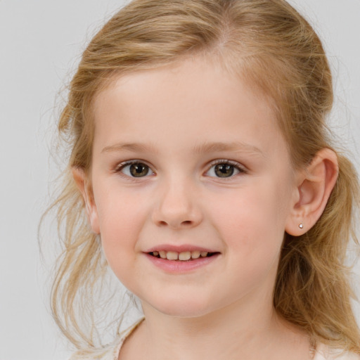 Joyful white child female with medium  brown hair and grey eyes