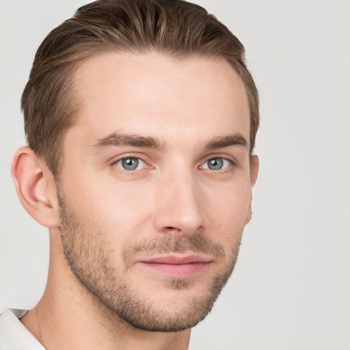 Joyful white young-adult male with short  brown hair and grey eyes