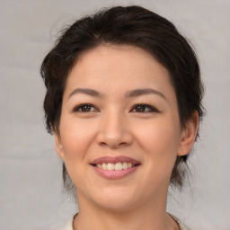 Joyful white young-adult female with medium  brown hair and brown eyes