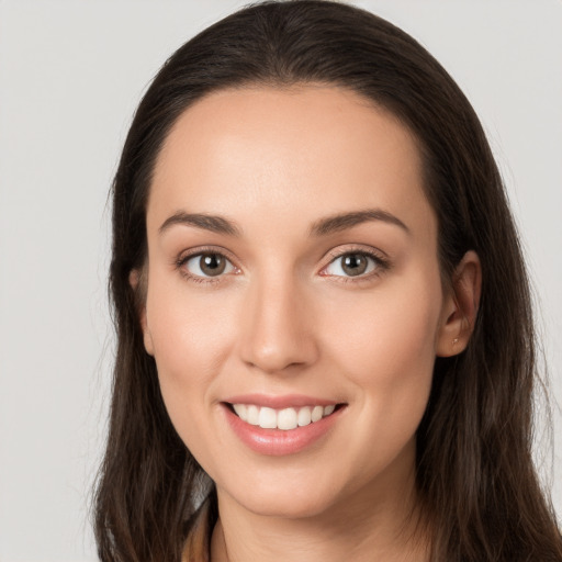 Joyful white young-adult female with long  brown hair and brown eyes