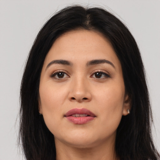 Joyful latino young-adult female with long  black hair and brown eyes