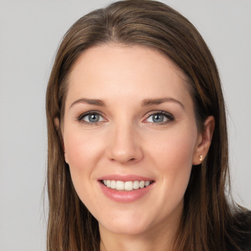 Joyful white young-adult female with long  brown hair and brown eyes