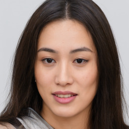 Joyful asian young-adult female with long  brown hair and brown eyes