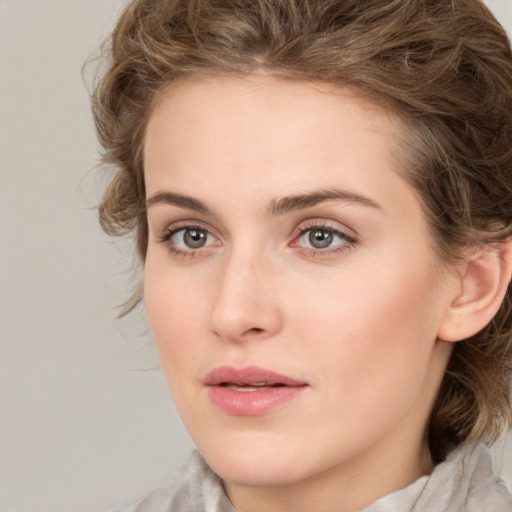 Joyful white young-adult female with medium  brown hair and green eyes