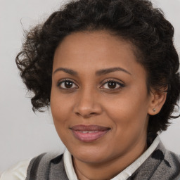 Joyful black young-adult female with medium  brown hair and brown eyes