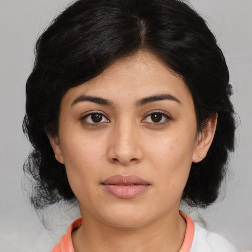 Joyful latino young-adult female with medium  black hair and brown eyes