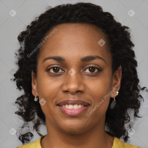 Joyful black young-adult female with long  brown hair and brown eyes