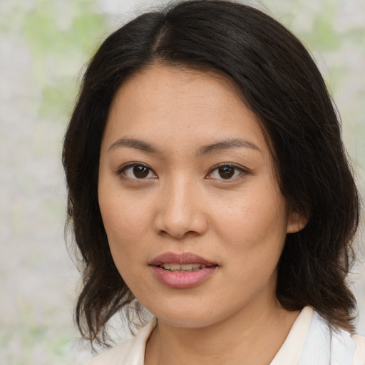 Joyful asian young-adult female with medium  brown hair and brown eyes