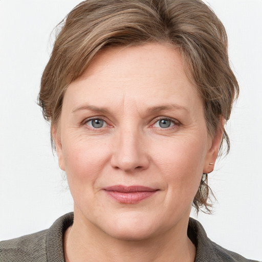 Joyful white adult female with medium  brown hair and grey eyes