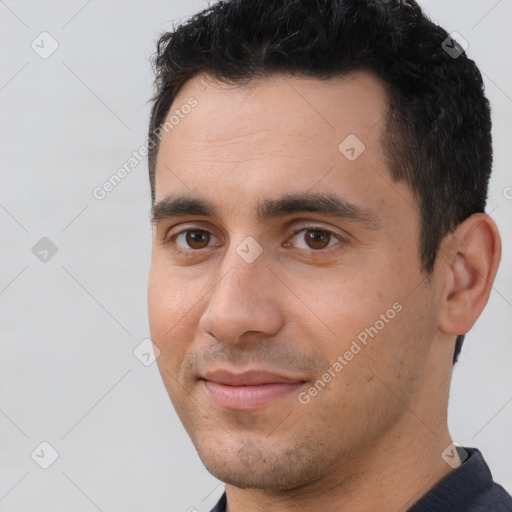 Joyful white young-adult male with short  black hair and brown eyes