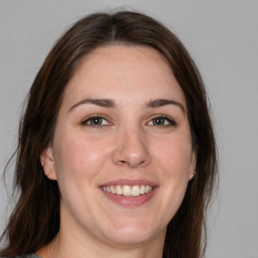 Joyful white young-adult female with medium  brown hair and brown eyes