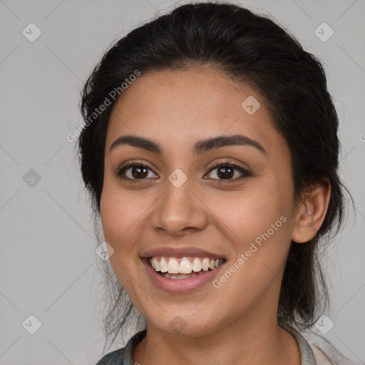 Joyful latino young-adult female with long  brown hair and brown eyes