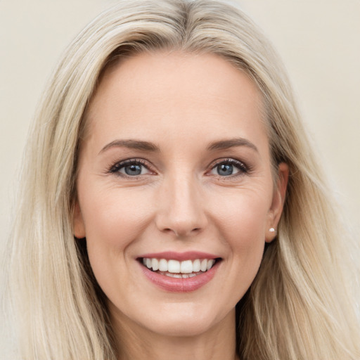 Joyful white young-adult female with long  brown hair and blue eyes