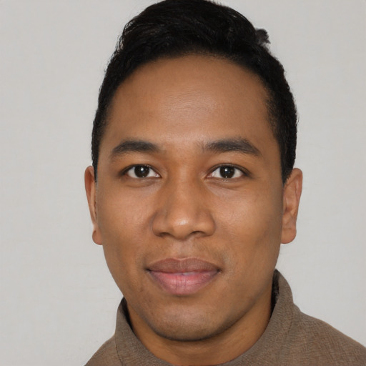 Joyful black young-adult male with short  black hair and brown eyes