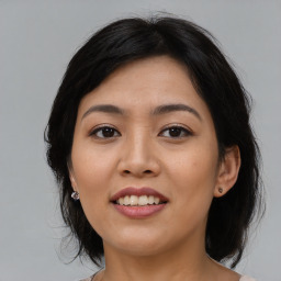 Joyful asian young-adult female with medium  black hair and brown eyes