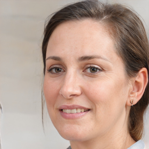 Joyful white adult female with medium  brown hair and brown eyes