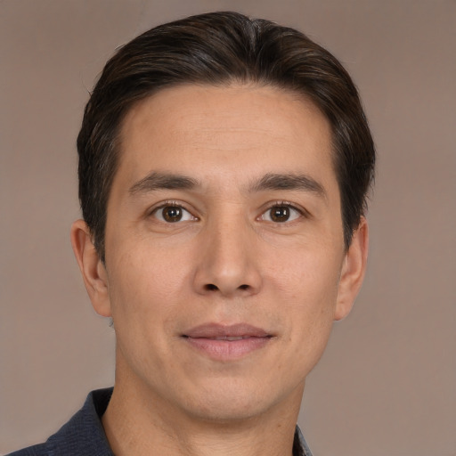 Joyful white adult male with short  brown hair and brown eyes