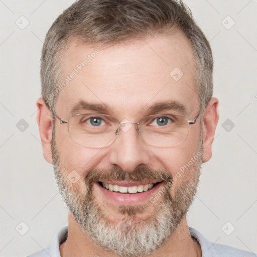 Joyful white adult male with short  brown hair and grey eyes