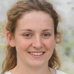 Joyful white young-adult female with medium  brown hair and blue eyes