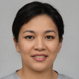 Joyful asian young-adult female with short  brown hair and brown eyes