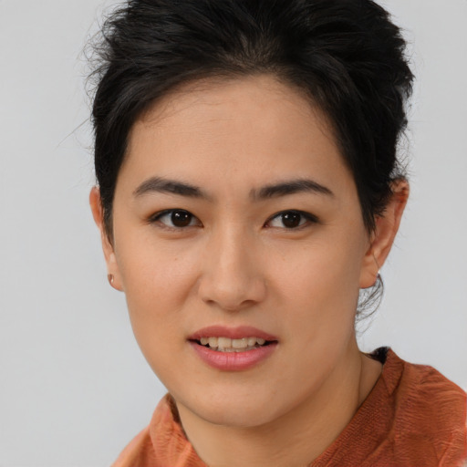 Joyful asian young-adult female with short  brown hair and brown eyes