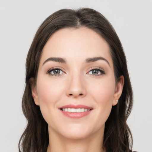 Joyful white young-adult female with long  brown hair and grey eyes