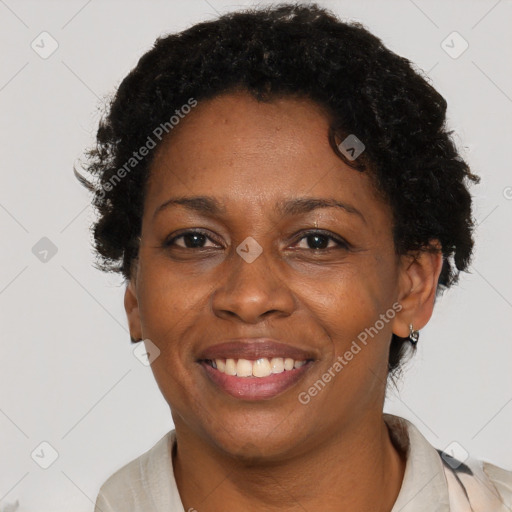 Joyful black adult female with short  brown hair and brown eyes