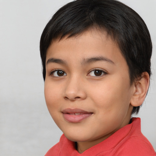 Joyful latino child female with short  brown hair and brown eyes