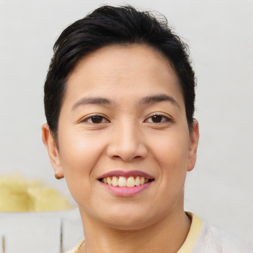 Joyful asian young-adult female with short  brown hair and brown eyes