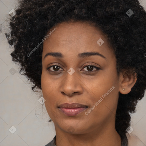 Joyful black adult female with long  brown hair and brown eyes