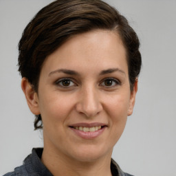 Joyful white young-adult female with short  brown hair and grey eyes