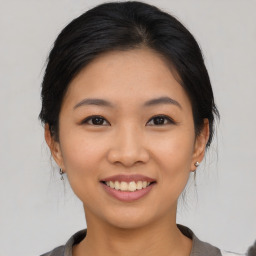 Joyful asian young-adult female with medium  black hair and brown eyes