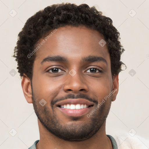 Joyful black young-adult male with short  brown hair and brown eyes