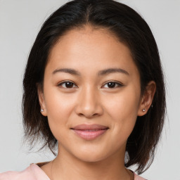 Joyful white young-adult female with medium  brown hair and brown eyes