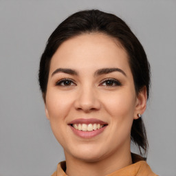 Joyful white young-adult female with medium  brown hair and brown eyes