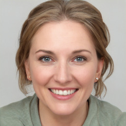 Joyful white young-adult female with medium  brown hair and blue eyes