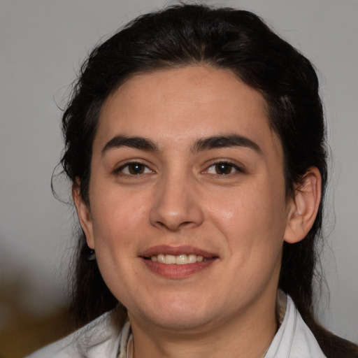 Joyful white young-adult female with medium  black hair and brown eyes