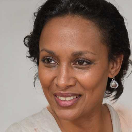 Joyful black adult female with medium  brown hair and brown eyes