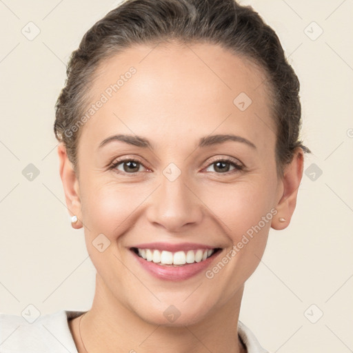 Joyful white young-adult female with short  brown hair and brown eyes